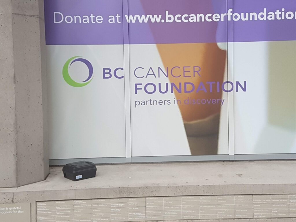 a poison station casually placed on a ledge at a bc cancer foundation building.